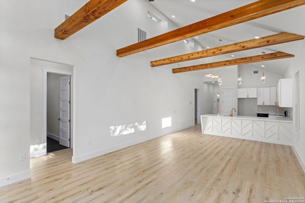 Empty room, Interior, Kitchen, Pendant Lights, Recessed Lighting, Stainless Steel Appliances, Wooden Beams, Wood Texture Flooring