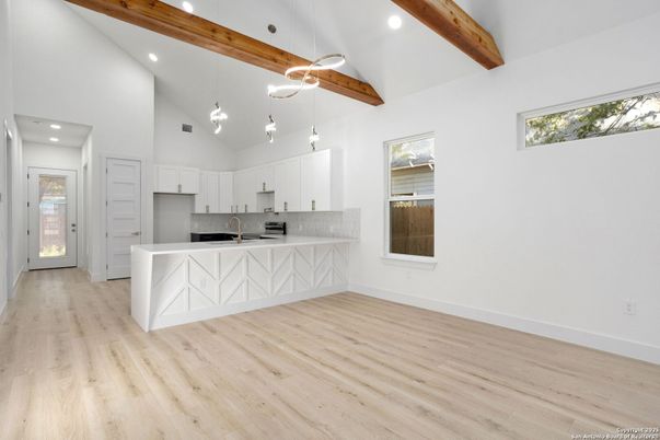 Empty room, Interior, Kitchen, Pendant Lights, Recessed Lighting, Stainless Steel Appliances, Wooden Beams, Wood Texture Flooring