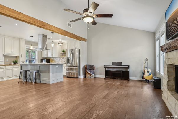 Fireplace, Interior, Kitchen, Pendant Lights, Piano, Recessed Lighting, Stainless Steel Appliances, Wooden Beams, Wood Texture Flooring
