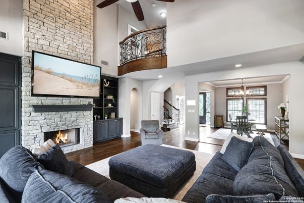 Dining room, Fireplace, Interior, Living room, Recessed Lighting, Stone Walls, Wood Texture Flooring