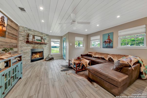 Fireplace, Interior, Living room, Recessed Lighting, Stone Walls, Wood Texture Flooring