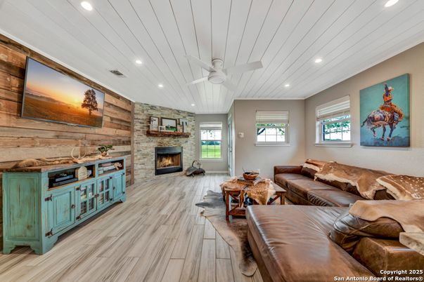 Fireplace, Interior, Living room, Recessed Lighting, Stone Walls, Wood Texture Flooring, Wooden Walls