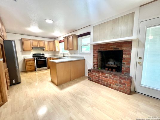 Fireplace, Interior, Kitchen, Recessed Lighting, Stone Walls, Wood Texture Flooring