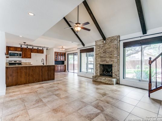 Empty room, Fireplace, Interior, Kitchen, Recessed Lighting, Stainless Steel Appliances, Stone Walls, Wooden Beams