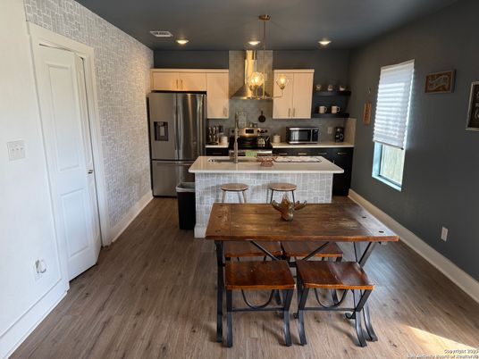 Dining room, Interior, Kitchen, Pendant Lights, Recessed Lighting, Stainless Steel Appliances, Wood Texture Flooring