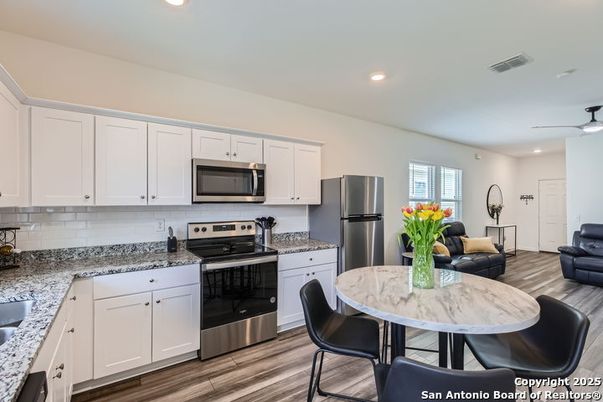 Dining room, Interior, Kitchen, Living room, Recessed Lighting, Stainless Steel Appliances, Wood Texture Flooring