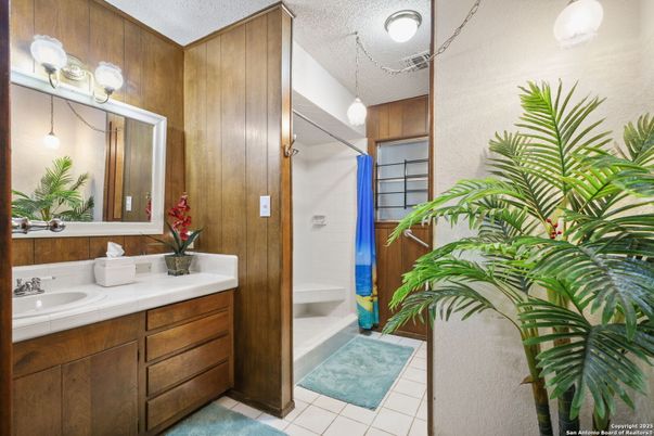 Bathroom, Dual Sink Vanities, Interior, Pendant Lights, Tile Countertops, Wooden Walls