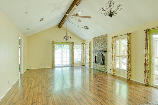 Chandelier, Empty room, Fireplace, Interior, Recessed Lighting, Wooden Beams, Wood Texture Flooring