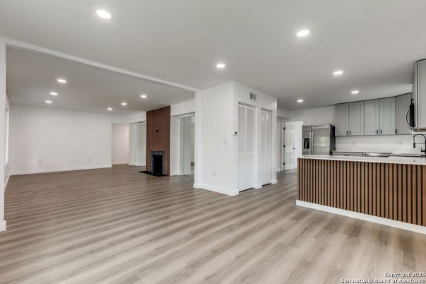 Empty room, Interior, Kitchen, Recessed Lighting, Stainless Steel Appliances, Wood Texture Flooring
