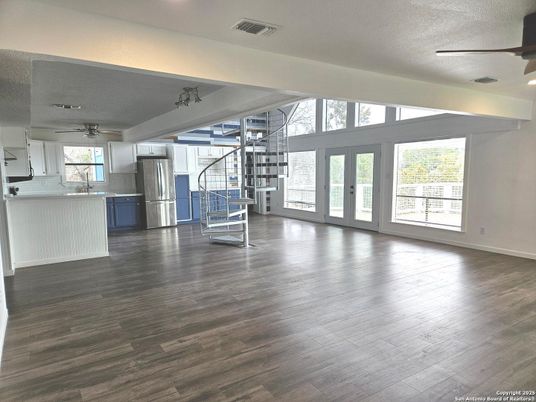 Empty room, Interior, Kitchen, Recessed Lighting, Stainless Steel Appliances, Wood Texture Flooring