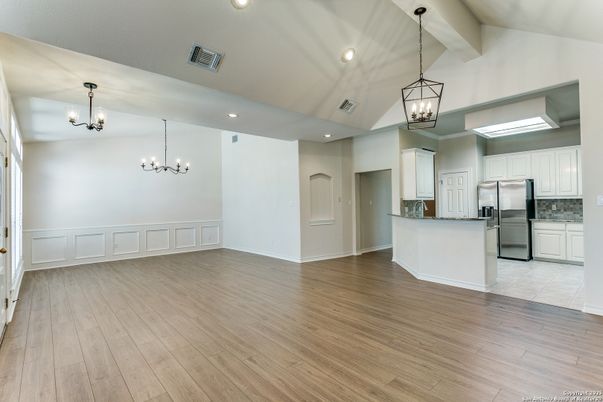 Chandelier, Empty room, Interior, Kitchen, Pendant Lights, Recessed Lighting, Stainless Steel Appliances, Wood Texture Flooring