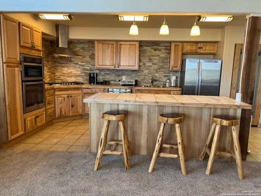 Interior, Kitchen, Stainless Steel Appliances, Stone Walls, Tile Countertops