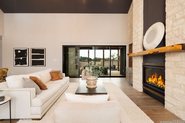 Fireplace, Interior, Living room, Recessed Lighting, Stone Walls, Wood Texture Flooring