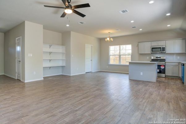 Chandelier, Empty room, Interior, Kitchen, Recessed Lighting, Stainless Steel Appliances, Wood Texture Flooring