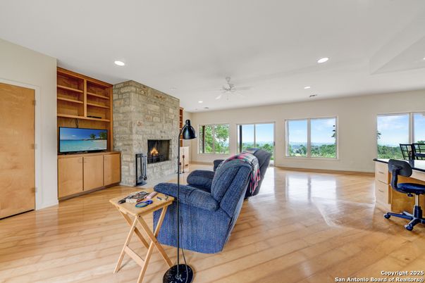 Fireplace, Interior, Living room, Recessed Lighting, Stone Walls, Wood Texture Flooring