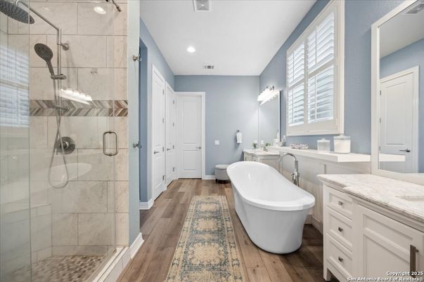 Bathroom, Dual Sink Vanities, Free Standing Baths, Glass Shower, Interior, Recessed Lighting, Wood Texture Flooring