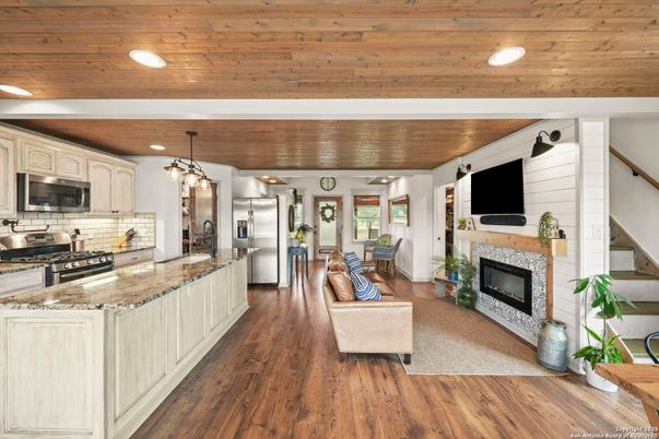 Fireplace, Interior, Kitchen, Living room, Pendant Lights, Recessed Lighting, Stainless Steel Appliances, Wooden Ceilings, Wood Texture Flooring