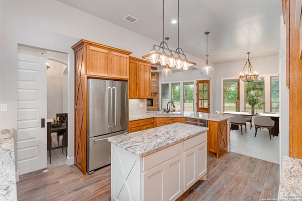 Chandelier, Dining room, Interior, Kitchen, Pendant Lights, Recessed Lighting, Stainless Steel Appliances, Wood Texture Flooring