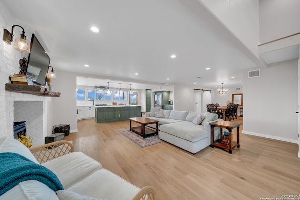 Chandelier, Dining room, Fireplace, Interior, Living room, Pendant Lights, Recessed Lighting, Wood Texture Flooring