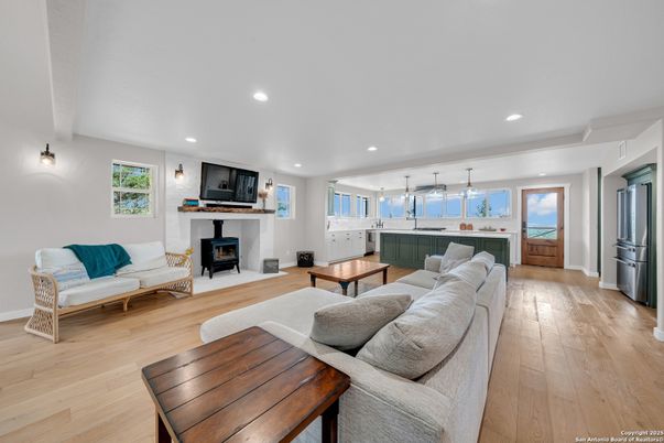 Fireplace, Interior, Kitchen, Living room, Pendant Lights, Recessed Lighting, Stainless Steel Appliances, Wood Texture Flooring