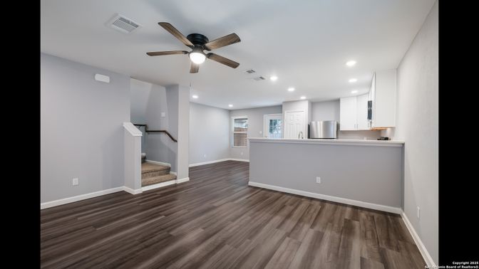 Empty room, Interior, Kitchen, Recessed Lighting, Stainless Steel Appliances, Wood Texture Flooring