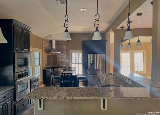 Interior, Kitchen, Pendant Lights, Recessed Lighting, Stainless Steel Appliances, Stone Walls