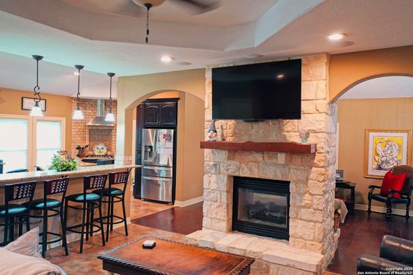 Fireplace, Interior, Kitchen, Pendant Lights, Recessed Lighting, Stainless Steel Appliances, Stone Walls, Wood Texture Flooring
