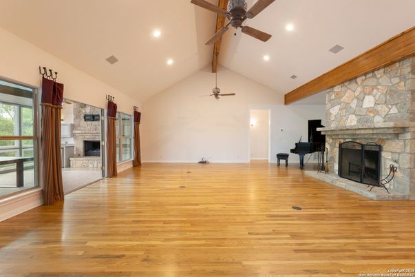 Empty room, Fireplace, Interior, Piano, Recessed Lighting, Stone Walls, Wooden Beams, Wood Texture Flooring