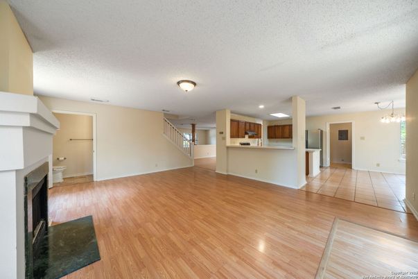 Empty room, Fireplace, Interior, Kitchen, Recessed Lighting, Wood Texture Flooring