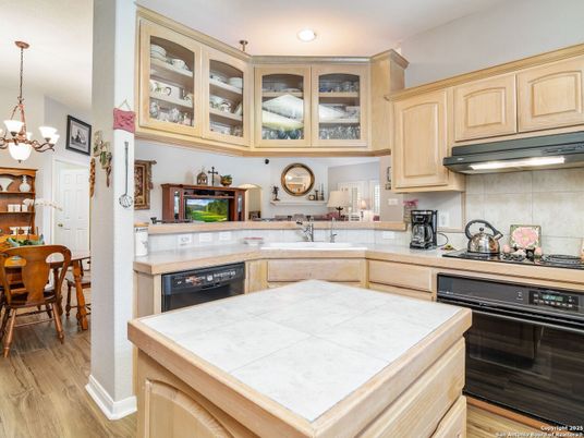 Chandelier, Dining room, Interior, Kitchen, Pendant Lights, Recessed Lighting, Tile Countertops, Wood Texture Flooring