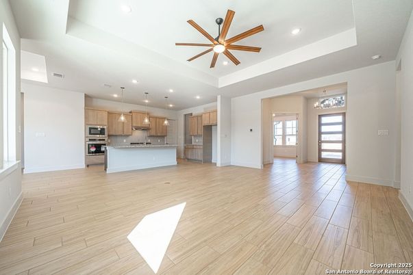 Chandelier, Empty room, Interior, Kitchen, Pendant Lights, Recessed Lighting, Stainless Steel Appliances, Wood Texture Flooring