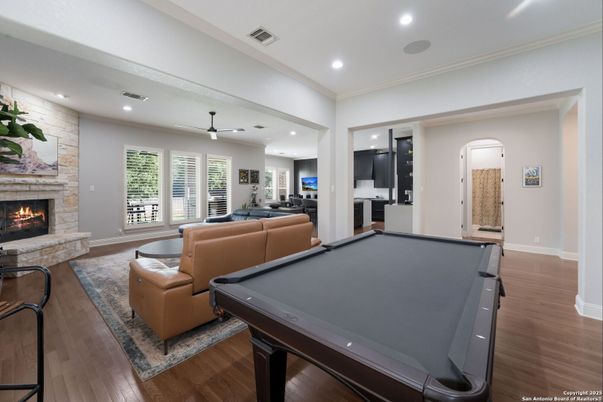 Billiard Table, Fireplace, Game Room, Interior, Living room, Recessed Lighting, Stone Walls, Wood Texture Flooring