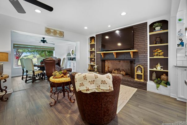 Dining room, Fireplace, Interior, Living room, Recessed Lighting, Stone Walls, Wood Texture Flooring