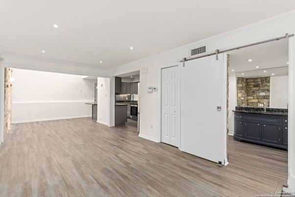 Empty room, Interior, Kitchen, Recessed Lighting, Stainless Steel Appliances, Wood Texture Flooring