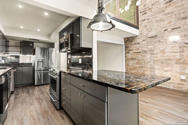 Interior, Kitchen, Pendant Lights, Recessed Lighting, Stainless Steel Appliances, Stone Walls, Wood Texture Flooring