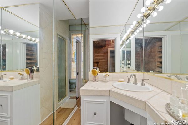 Bathroom, Dual Sink Vanities, Glass Shower, Interior, Tile Countertops, Wood Texture Flooring