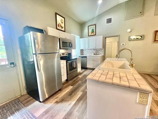 Interior, Kitchen, Recessed Lighting, Tile Countertops, Wood Texture Flooring