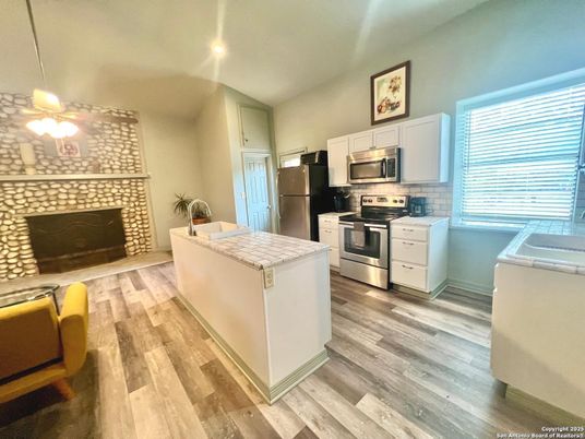 Fireplace, Interior, Kitchen, Recessed Lighting, Stainless Steel Appliances, Wood Texture Flooring