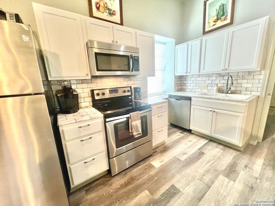 Interior, Kitchen, Stainless Steel Appliances, Tile Countertops, Wood Texture Flooring