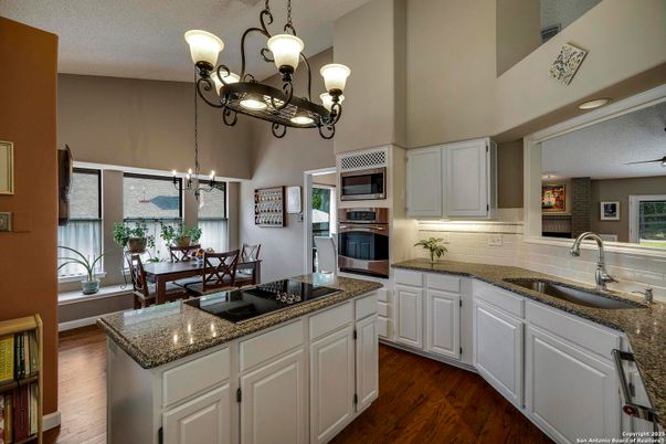 Chandelier, Dining room, Interior, Kitchen, Pendant Lights, Stainless Steel Appliances, Wood Texture Flooring