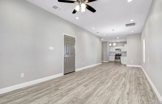 Empty room, Interior, Kitchen, Pendant Lights, Recessed Lighting, Stainless Steel Appliances, Wood Texture Flooring