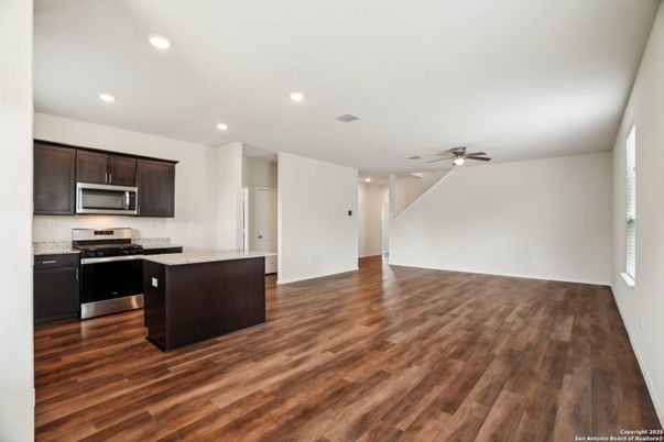 Empty room, Interior, Kitchen, Recessed Lighting, Stainless Steel Appliances, Wood Texture Flooring