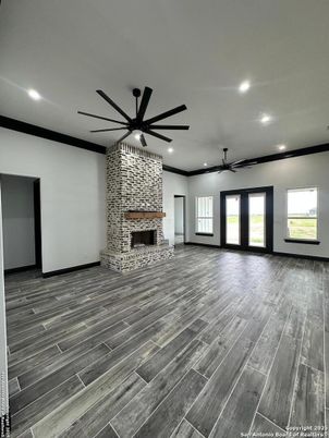 Empty room, Fireplace, Interior, Recessed Lighting, Stone Walls, Wood Texture Flooring