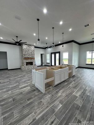 Empty room, Fireplace, Interior, Kitchen, Pendant Lights, Recessed Lighting, Stone Walls, Wood Texture Flooring