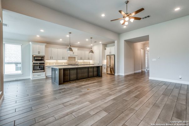 Empty room, Interior, Kitchen, Pendant Lights, Recessed Lighting, Stainless Steel Appliances, Wood Texture Flooring