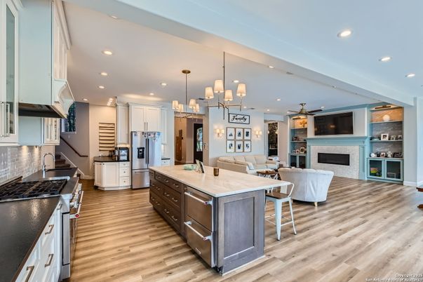 Fireplace, Interior, Kitchen, Living room, Pendant Lights, Recessed Lighting, Stainless Steel Appliances, Wood Texture Flooring