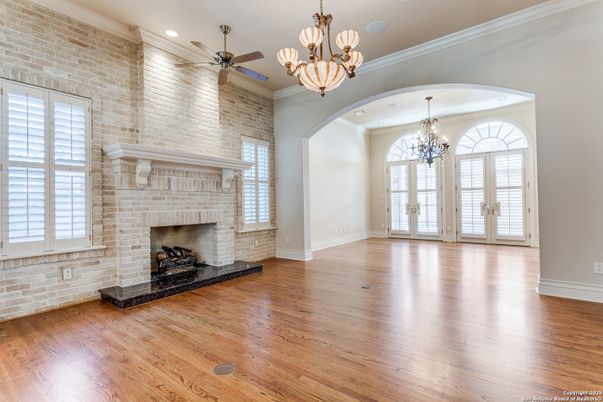 Chandelier, Empty room, Fireplace, Interior, Recessed Lighting, Stone Walls, Wood Texture Flooring