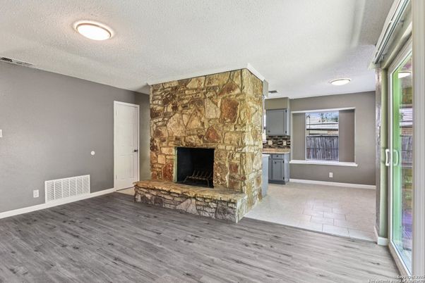 Empty room, Fireplace, Interior, Recessed Lighting, Stone Walls, Wood Texture Flooring
