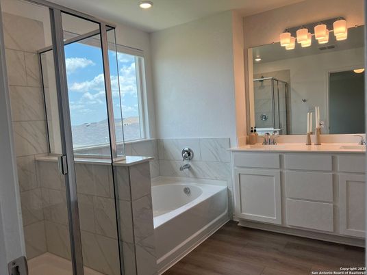 Bathroom, Dual Sink Vanities, Glass Shower, Interior, Marble Walls, Recessed Lighting, Wood Texture Flooring