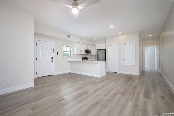 Empty room, Interior, Kitchen, Recessed Lighting, Stainless Steel Appliances, Wood Texture Flooring